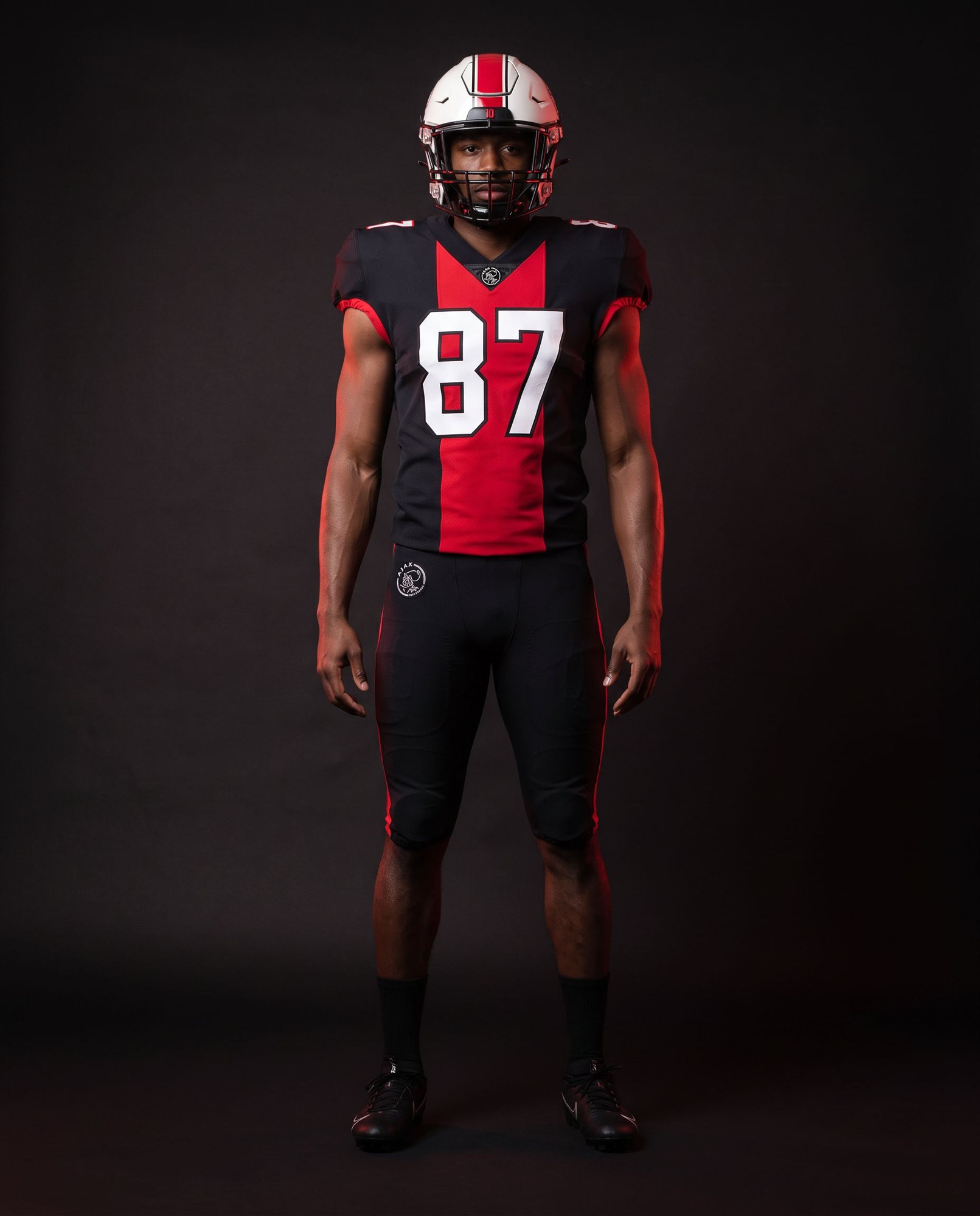 Ajax wide receiver in the black away uniform with the wide red centre band and number 87