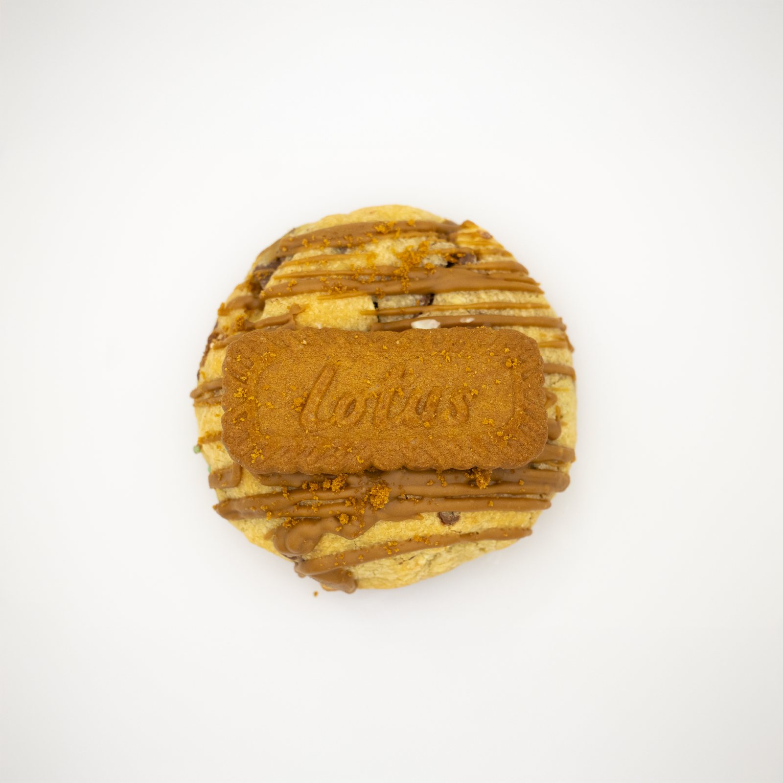Lotus Biscoff cookie topped with white chocolate drizzle, shot from above