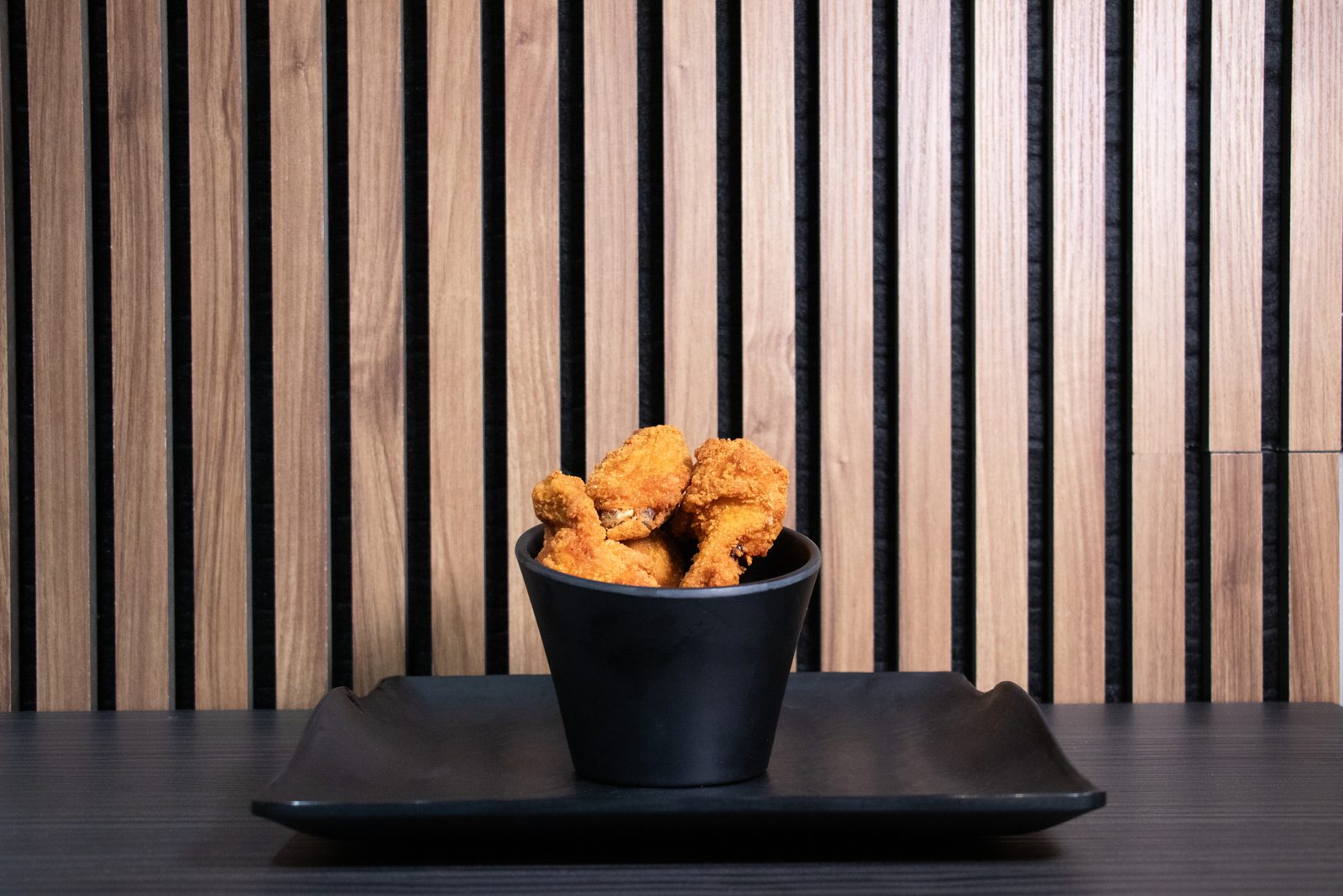 Chicken strips in a black cup