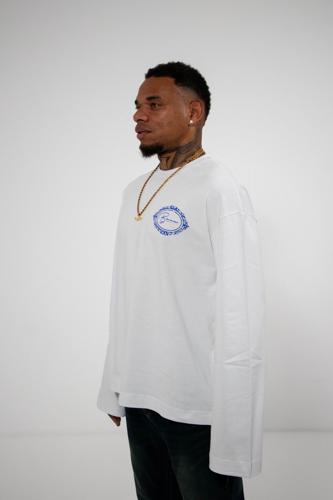 Model in a white BACU longsleeve, side view