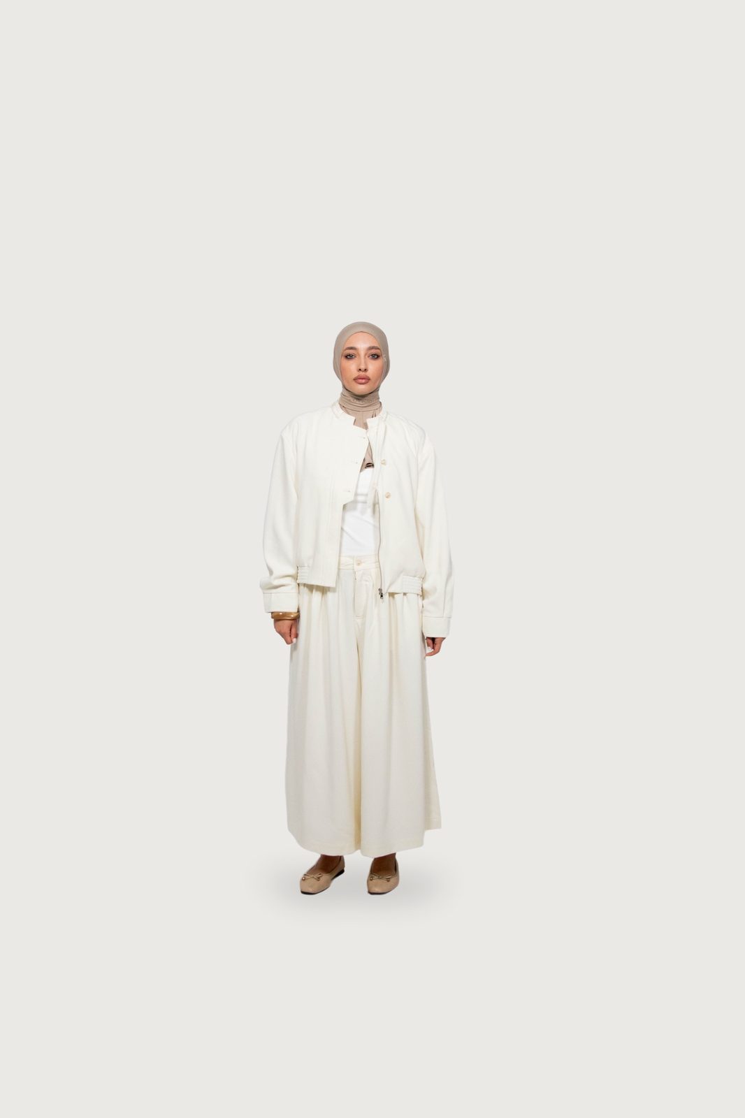 Model in a cream Kallouchi jacket and long skirt