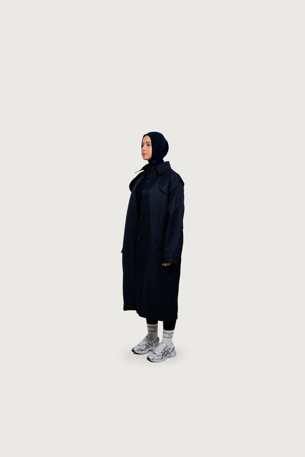 Model in a long navy Kallouchi coat