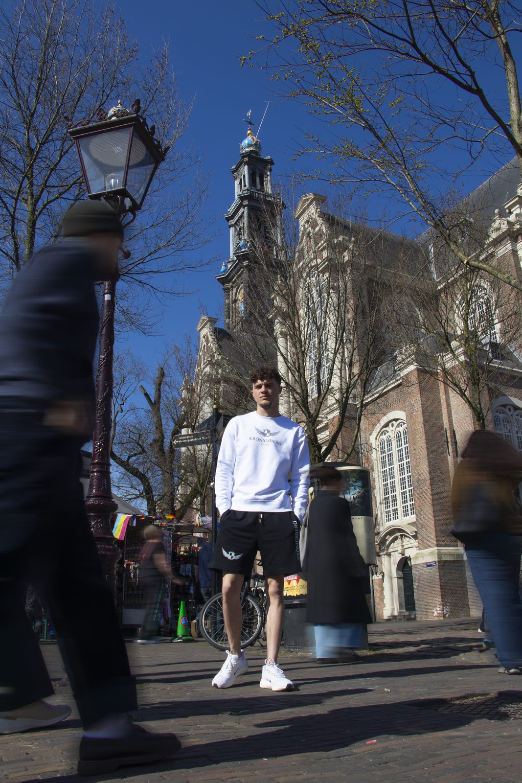 Model in a white Kronigsberg sweatshirt by the Westerkerk