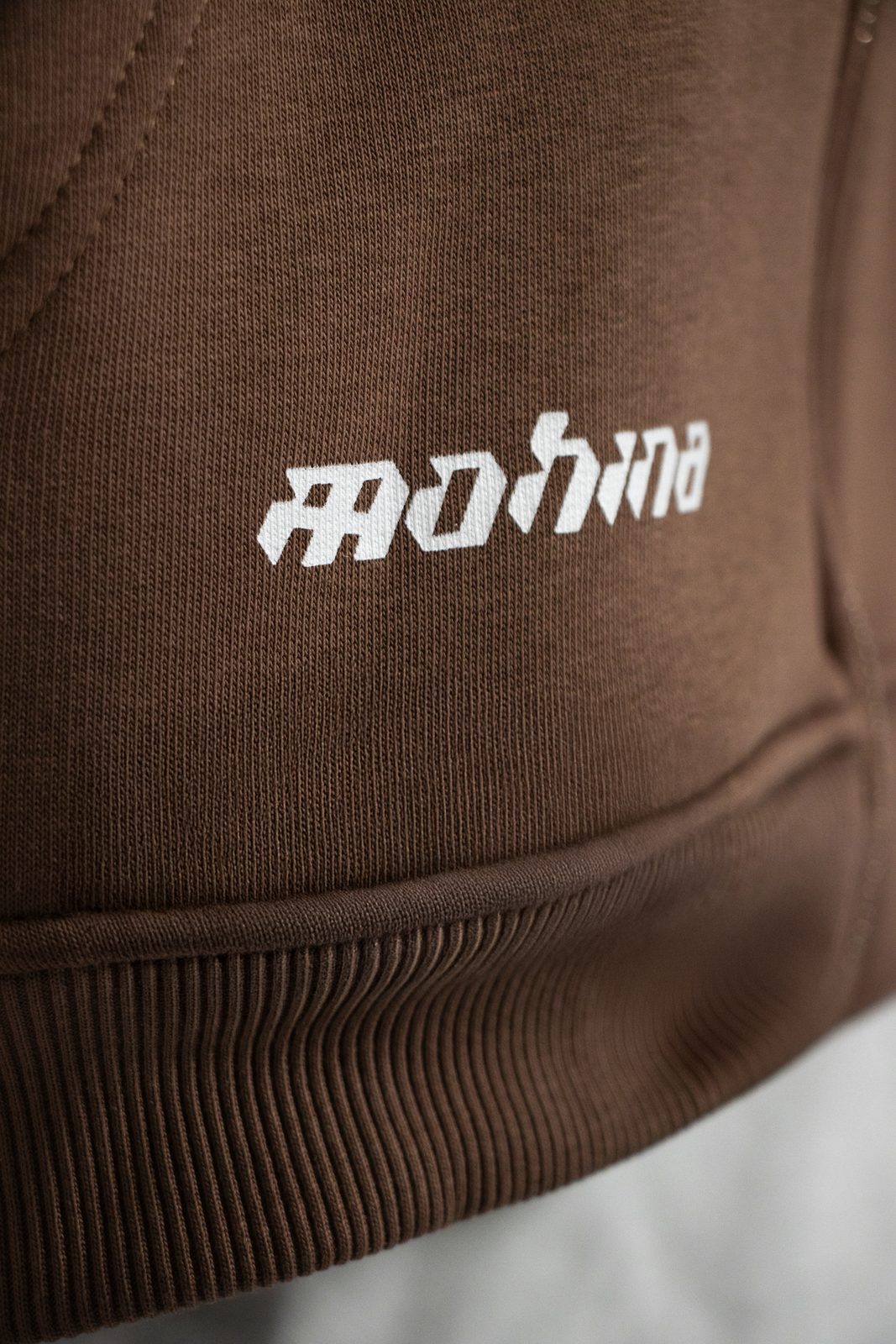 Close-up of the Mohina logo on the hoodie hem