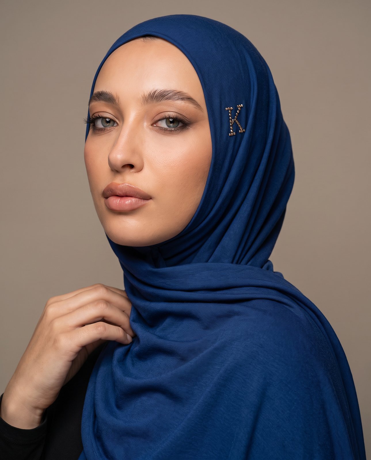 AI image: model in a royal-blue hijab with the crystal K