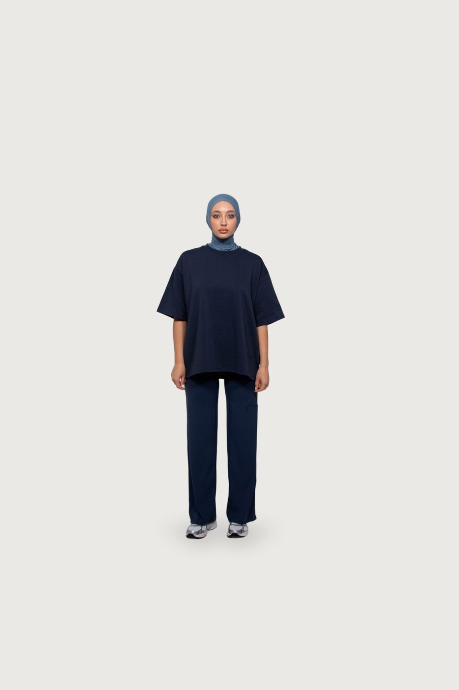 Model in a navy two-piece with a blue hijab