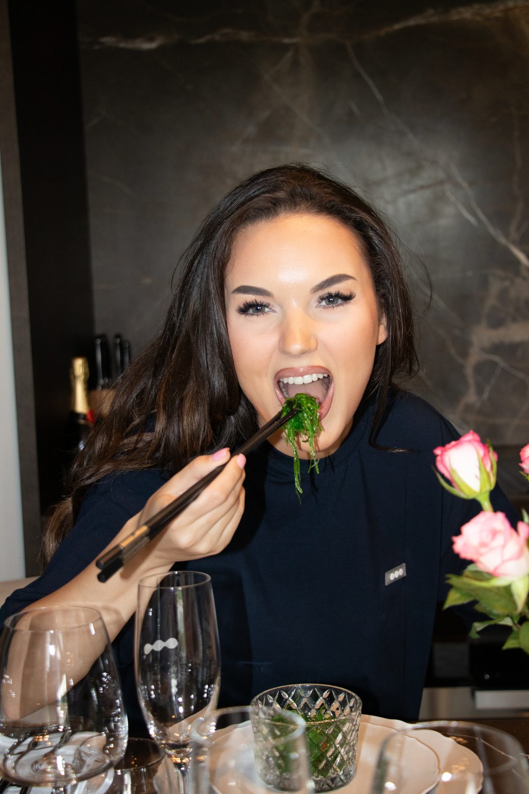 Guest laughing with food on her fork at the LMF dinner