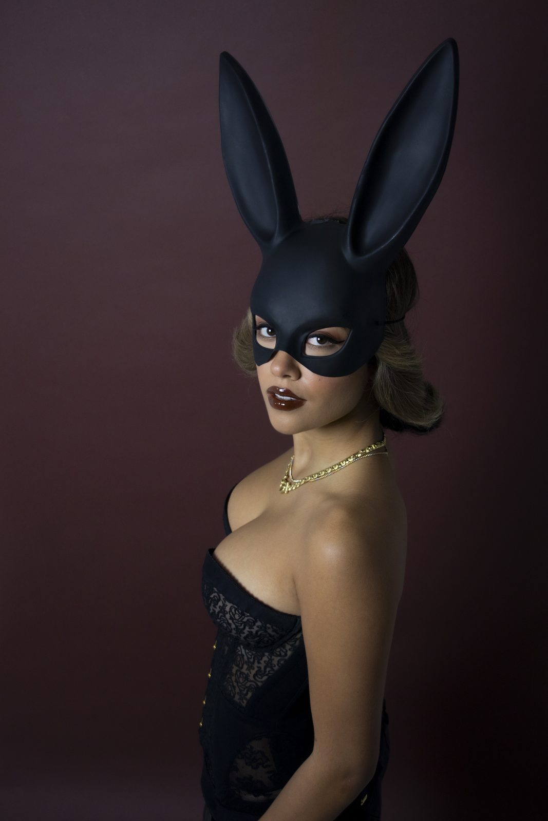 Model in a bunny mask turned three-quarters to the camera