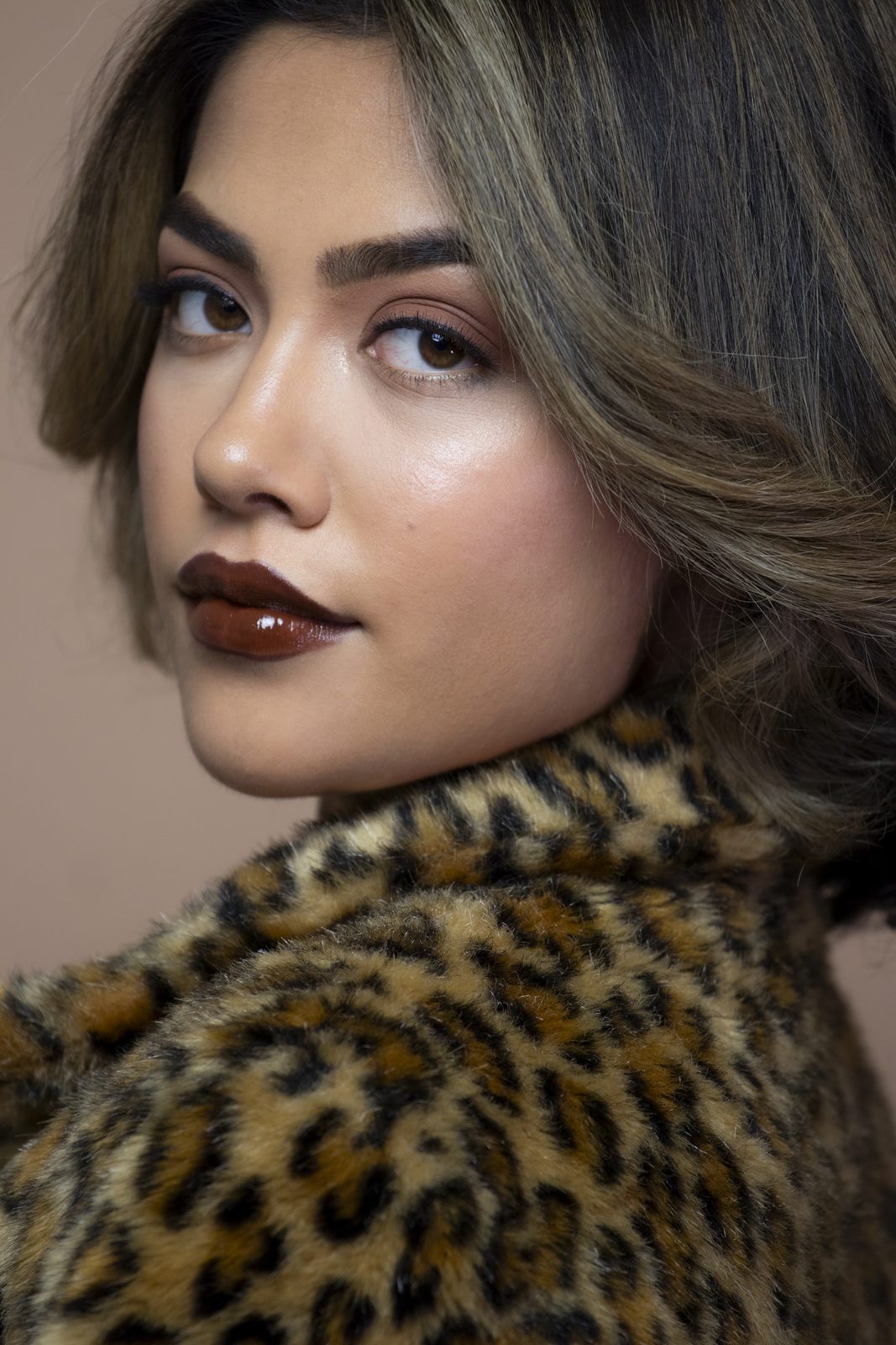 Close-up of a model looking over her shoulder in leopard fur