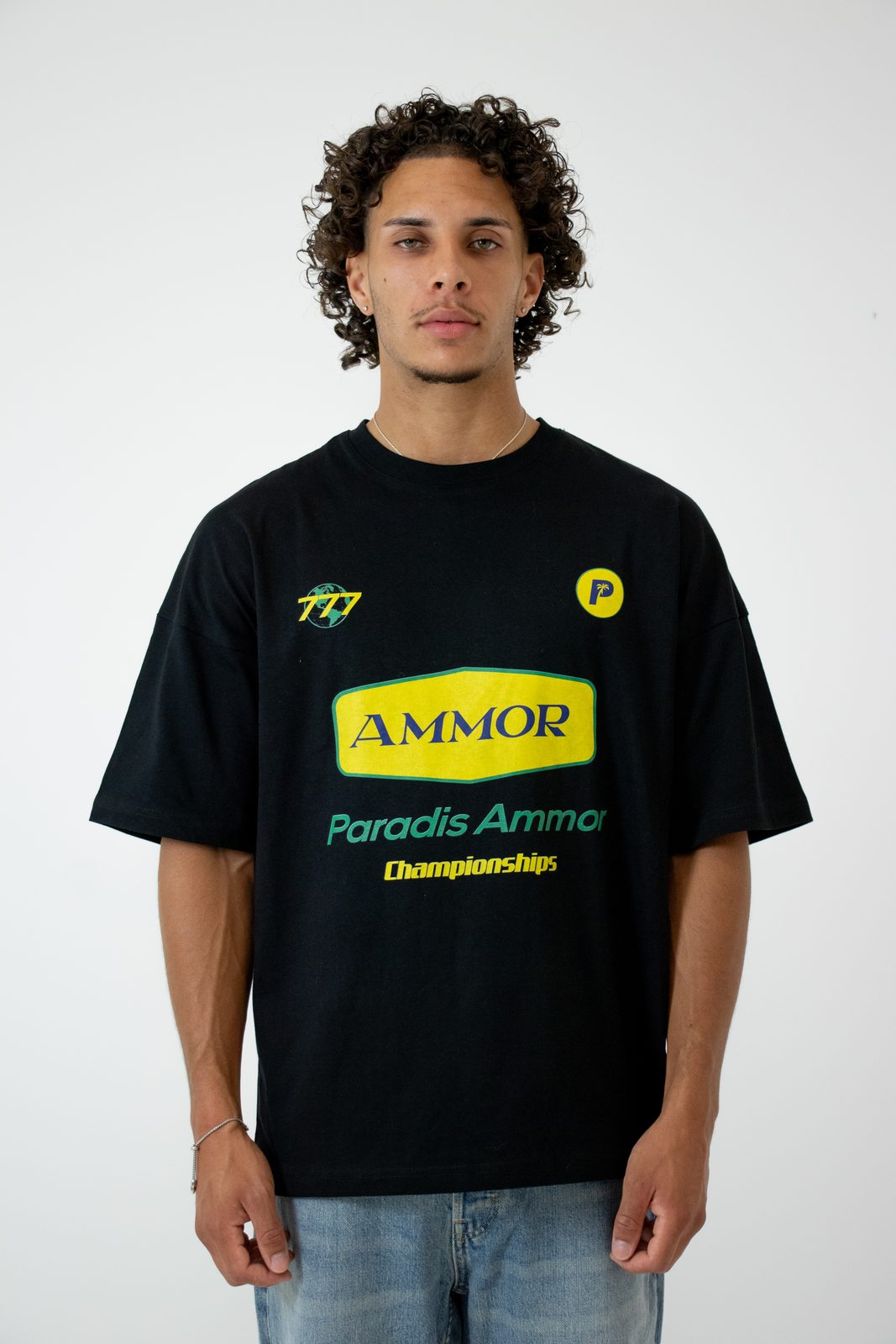 Model in a black Ammor Championship tee with yellow and green print