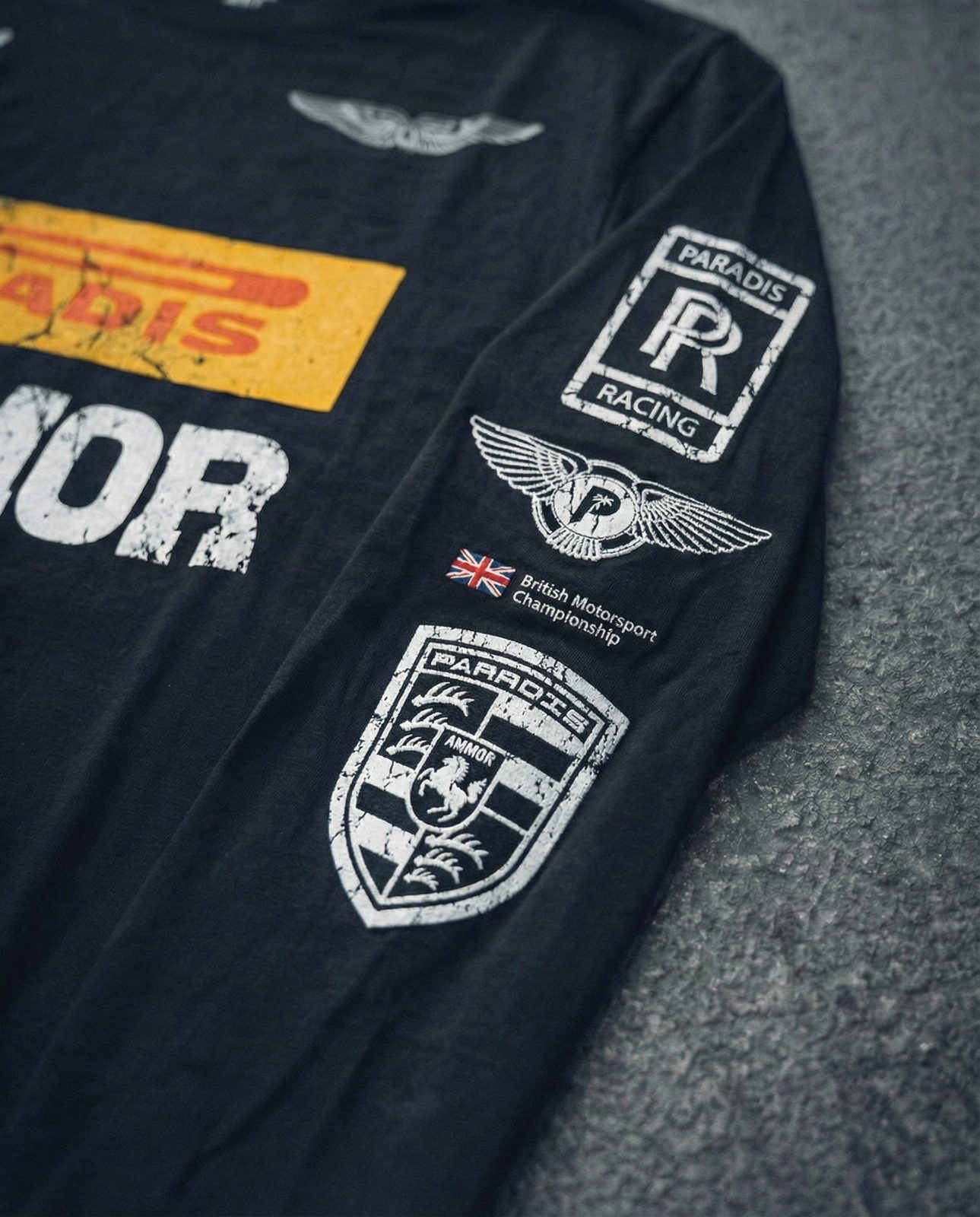 AI image: close-up of the sleeve badges on the racing longsleeve on asphalt