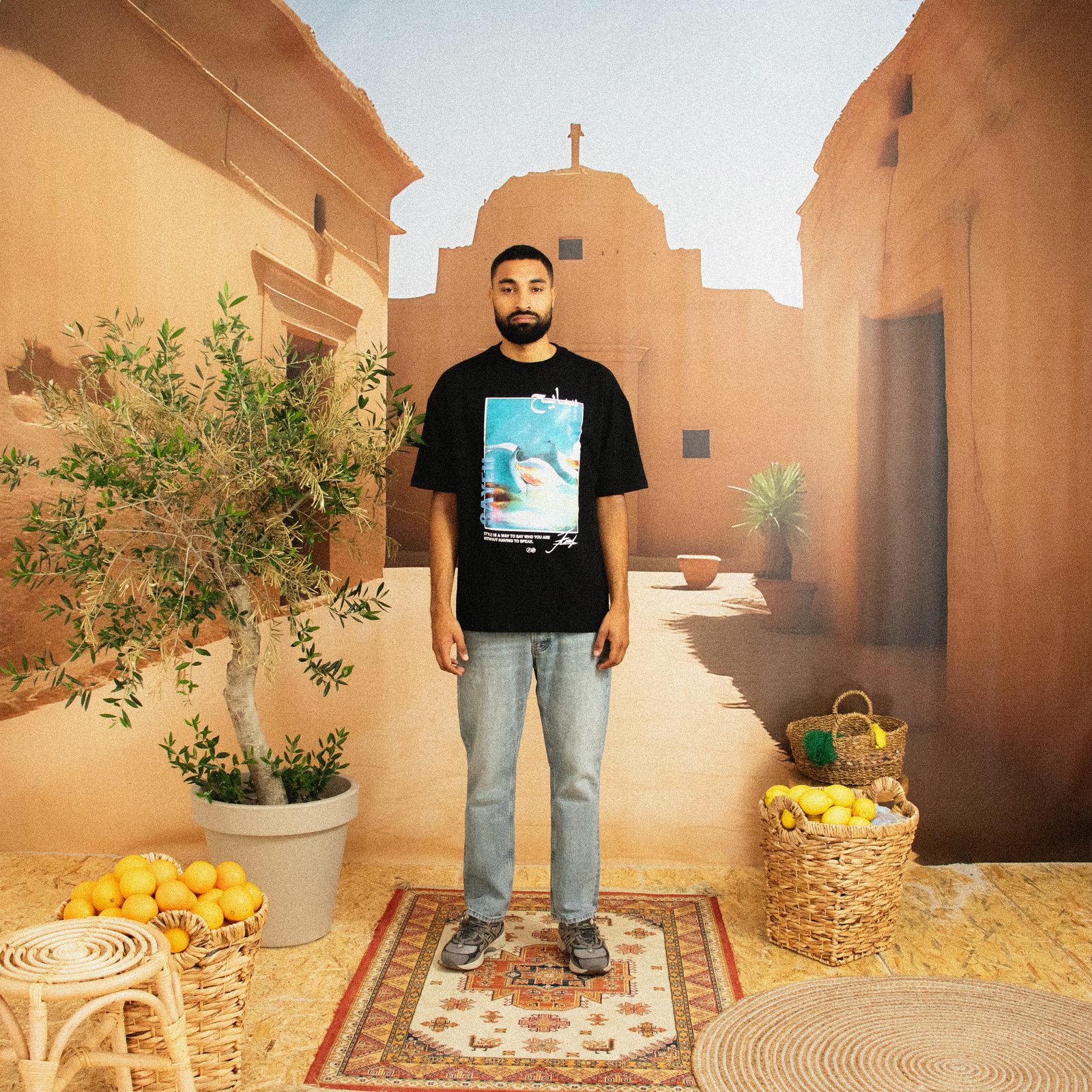 Model in a black SAYEH printed tee on the Marrakech set