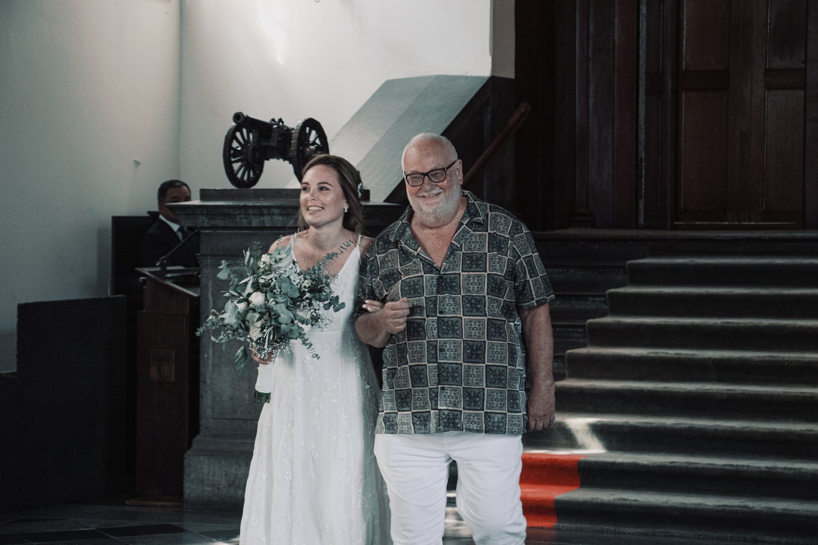 Imre walking down the stairs with her father