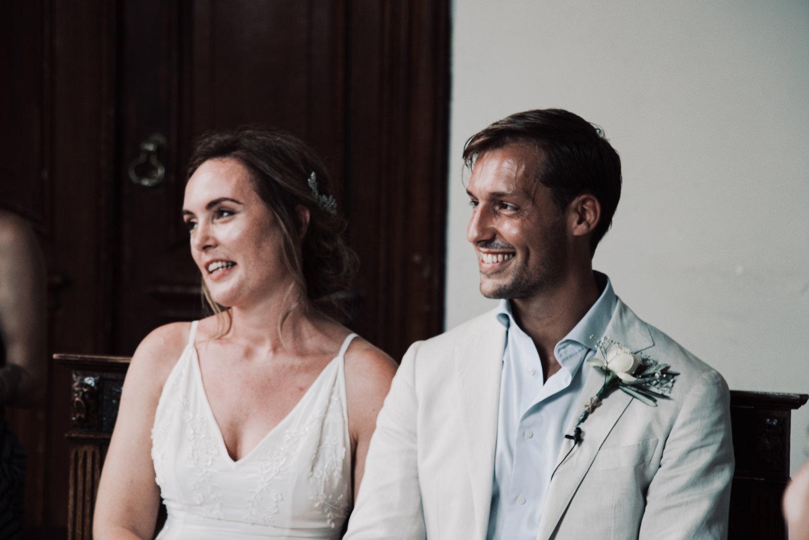 Imre and Chris seated side by side, laughing during the ceremony
